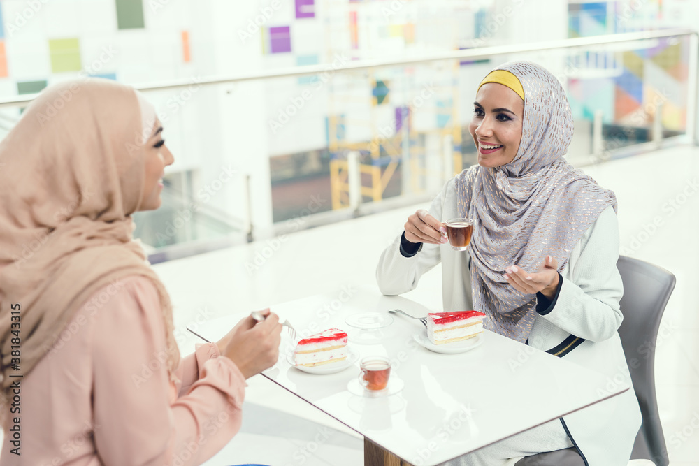 Young Arabian Women Sitting in Cafe in Modern Mall