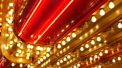 Old fasioned electric lamps blinking and glowing at night. Abstract close up of retro casino decoration shimmering in Las Vegas, USA. Illuminated vintage style bulbs glittering on Freemont street