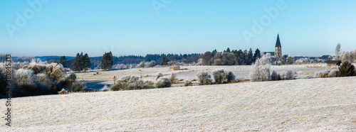 winter landscape of the fields church of the small countryside Belgian town of Paliseul