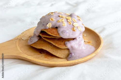 Homemade diet pancake with mixed fruits yogurt on white bed in the morning.