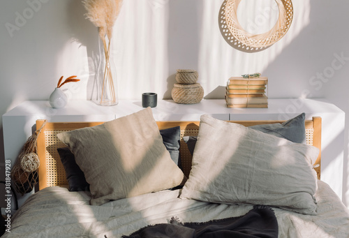 Cozy bedroom in Scandinavian style, shadows on the wall. Home decoration concept.