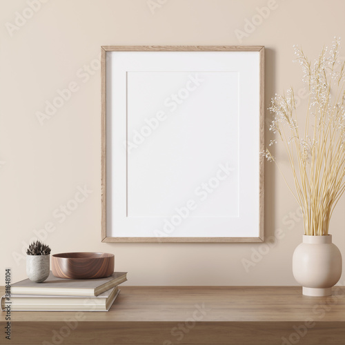 3d render of a modern beige mockup interior with wooden frame on an empty wall and a light beige vase with pampas grass, books and cactus 