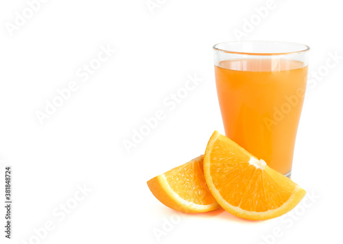 Glass of fresh orange juice with fresh orange slices cut in half on white background with copy space, banner