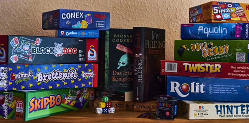 BERLIN, GERMANY - Sep 06, 2020: Books and many different packs of board games. photo