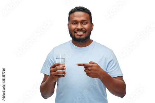 healthy eating, diet and people concept - happy smiling african american man showing glass of water over white background