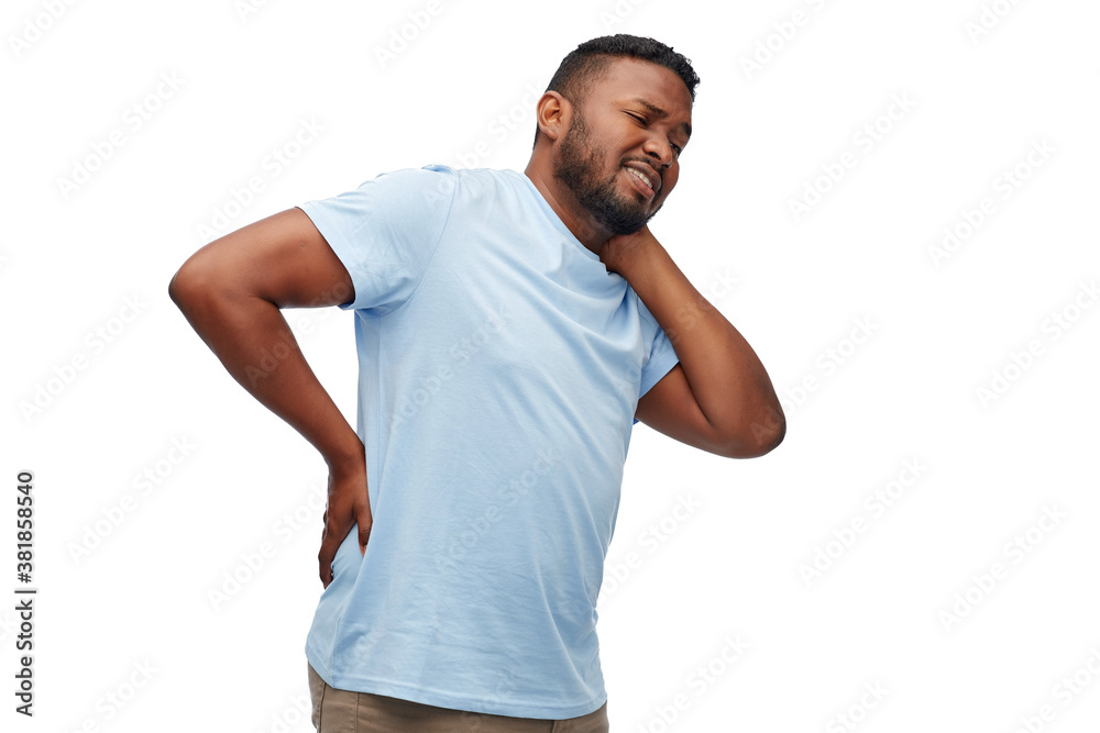 health problem and people concept - unhappy african american man suffering from pain in lower back or reins over white background health problem and people concept - unhappy african american man suffering from pain in lower back or reins over white background