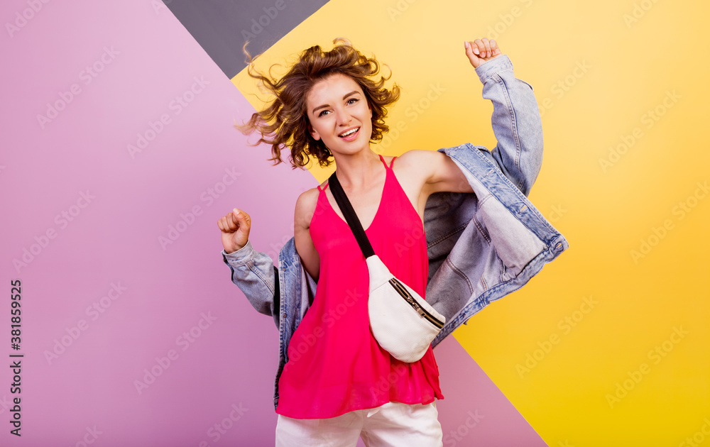 Funny woman with short wavy hairs dancing and having fun on multicolor background. Copy space for text. Funny woman with short wavy hairs dancing and having fun on multicolor background. Copy space for text.