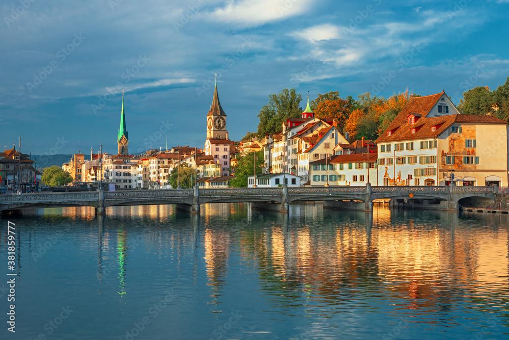 Amazing sunrise view on historic Zurich city center with famous Fraumunster and Grossmunster churches and river Limmat, Switzerland