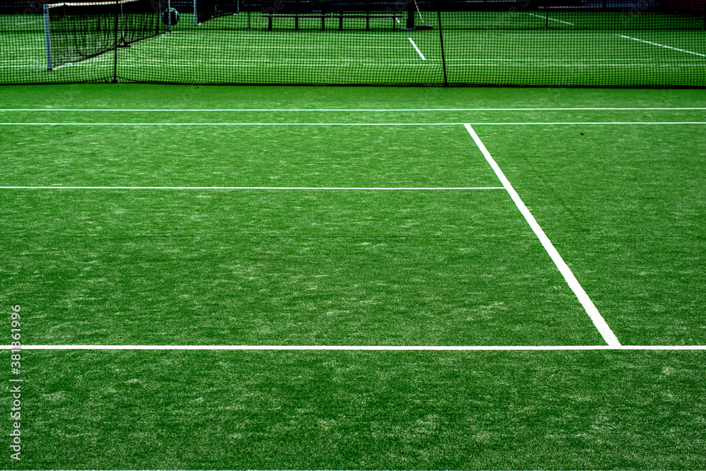 Fototapeta premium White lined green grass tennis court