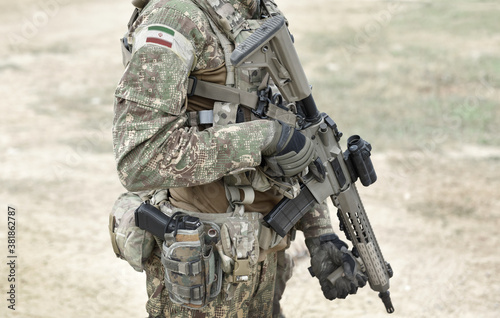 Soldier with assault rifle and flag of Iran on military uniform. Collage.