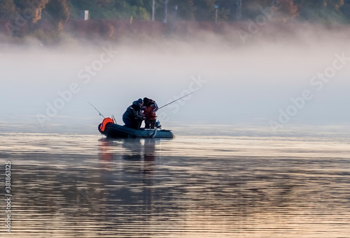 Fishing boat with silhouettes of  happy fishermen and their catch, Baltic reg...