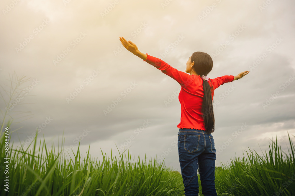 Happy Asian woman open arms stay on rice fields feeling happy in nature. Happy Asian woman open arms stay on rice fields feeling happy in nature.