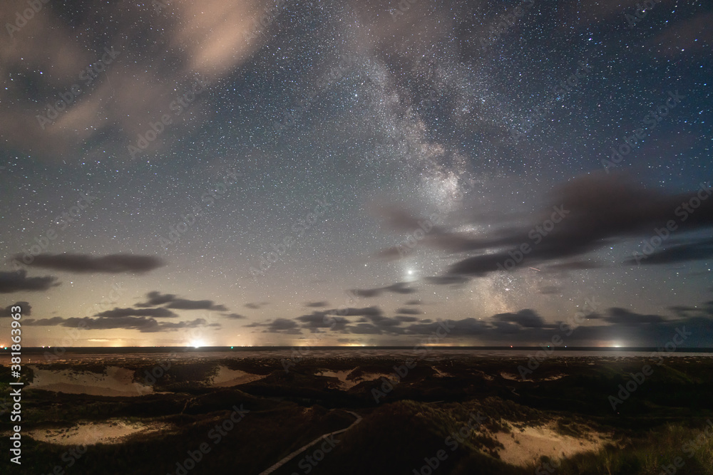 Fototapeta premium Wolken und Sternenhimmel mit Milchstraße. Amrum Dünenlandschaft