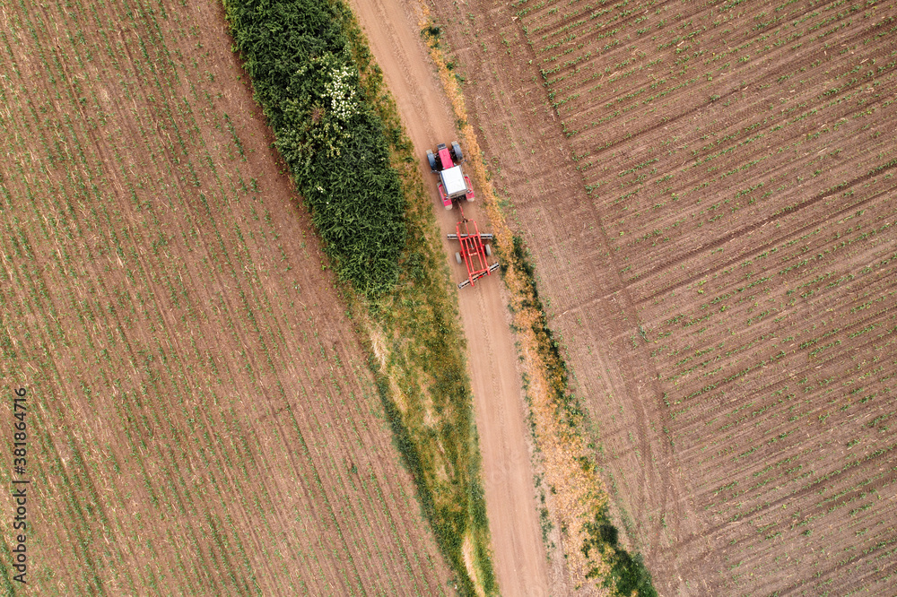 Aerial view of agricultural tractor on dirt road Aerial view of agricultural tractor on dirt road