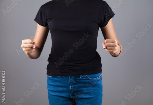 The young emotional angry woman on an isolated gray background.