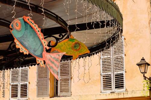 Closeup shot of colorful decorative fish hanging from a ceiling of a pavilion photo