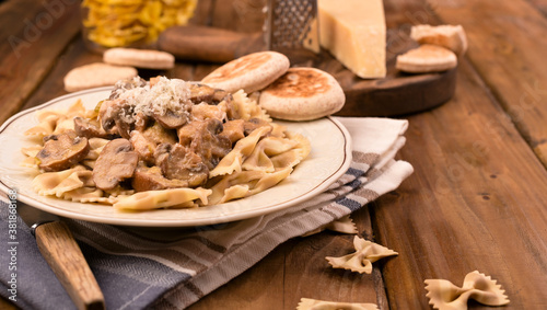 Pasta with mushrooms and tigelle. Butterfly pasta with parmesan and cheese sauce. Typical italian cuisine from the south of italy. High quality photo. Copy space