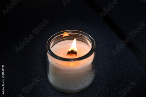 burning candles with wooden wick