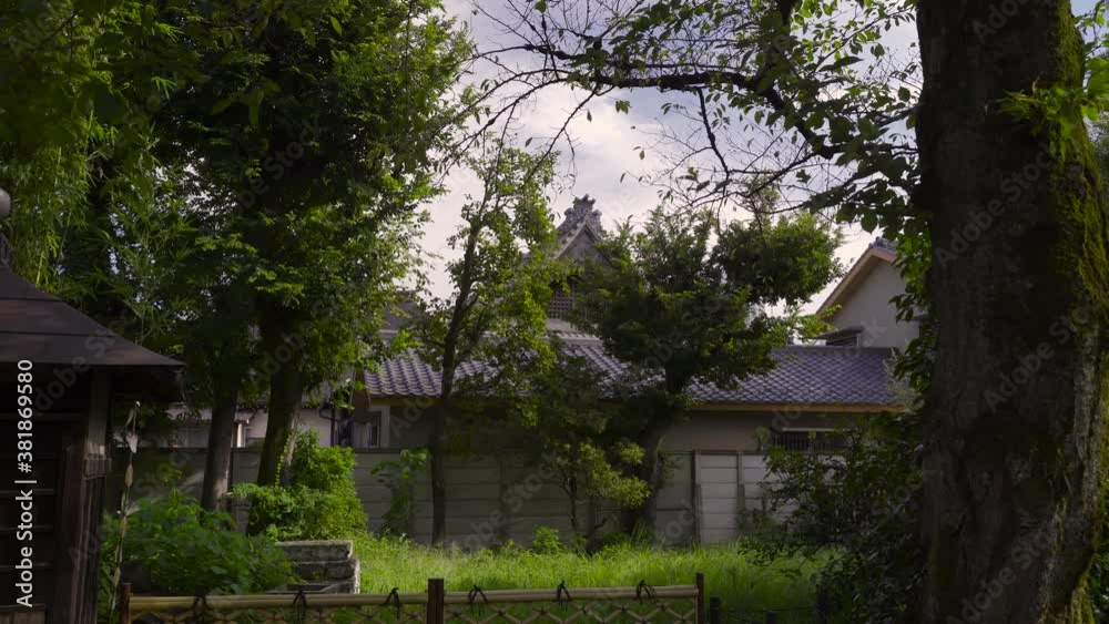 Creepy view into Japanese nature backyard with typical architecture buildings on windy day Creepy view into Japanese nature backyard with typical architecture buildings on windy day