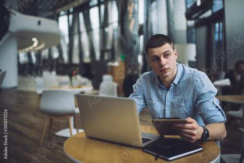 Serious man working on project in cafe