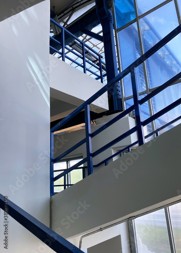 Flight of stairs. Stairs with blue metal railings