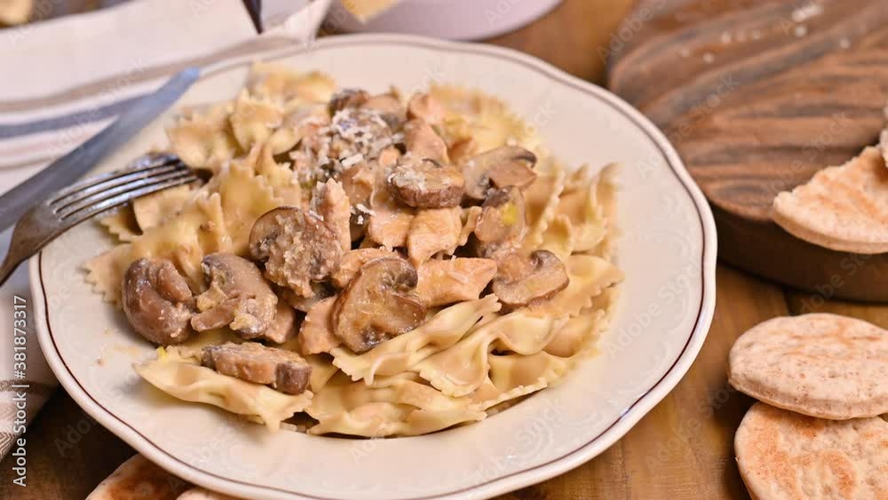 Butterfly pasta with mushrooms and parmesan cheese sauce. Typical italian cuisine from the south of italy. High quality 4k footage Butterfly pasta with mushrooms and parmesan cheese sauce. Typical italian cuisine from the south of italy. High quality 4k footage