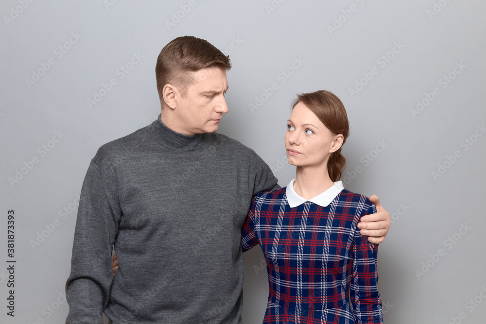 Portrait of serious man and woman hugging and looking at each other Portrait of serious man and woman hugging and looking at each other
