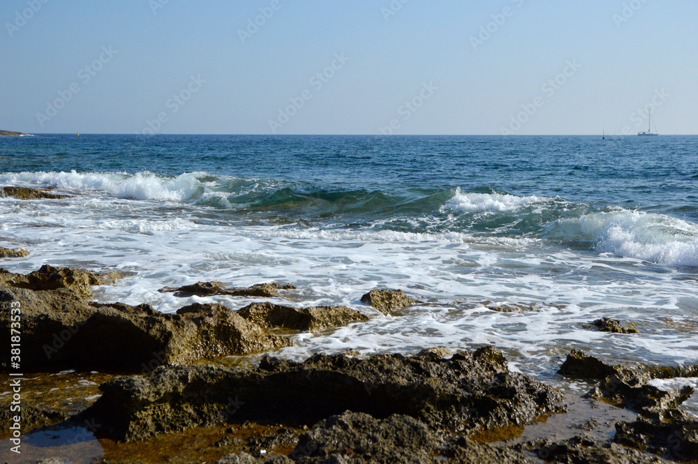 rocky sea shore background in bright sunny day