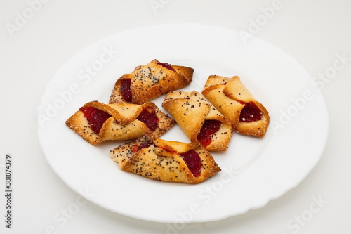 Testy cookes with jam on a white plate