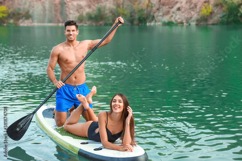 Young couple using paddle b...