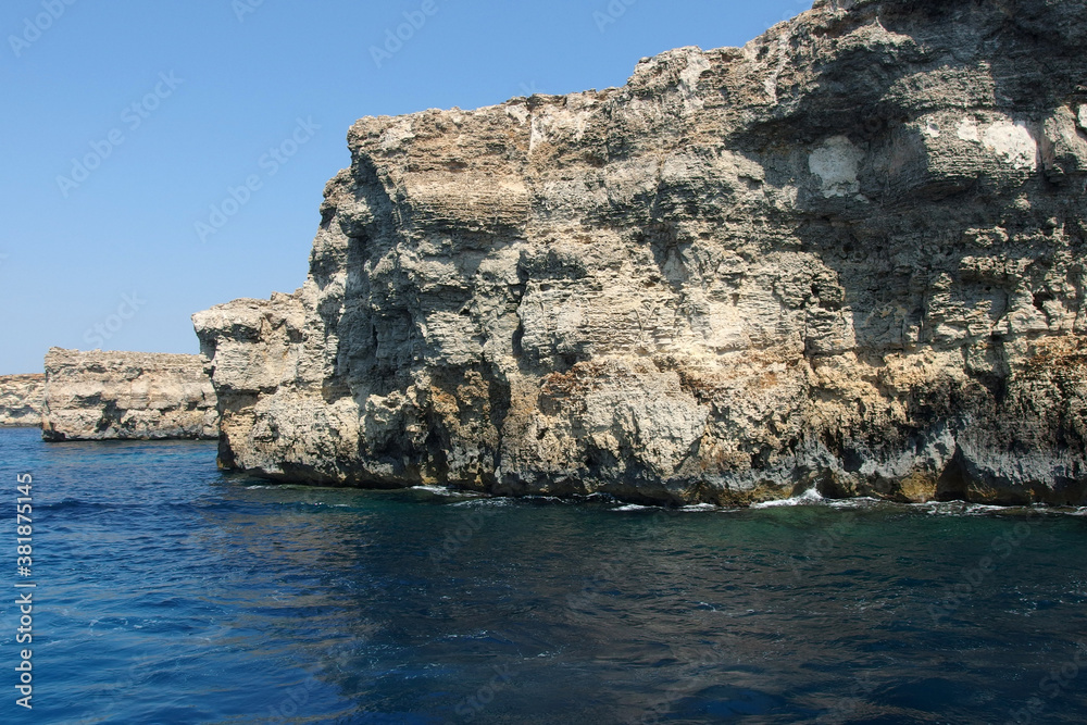Fototapeta premium rocky coastline on Malta island with calm blue sea