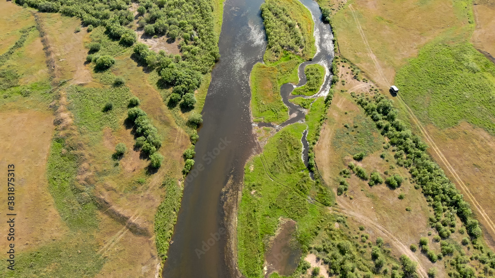 Wide river surrounded by meadows and trees near ground road with driving car, Wide river surrounded by meadows and trees near ground road with driving car,