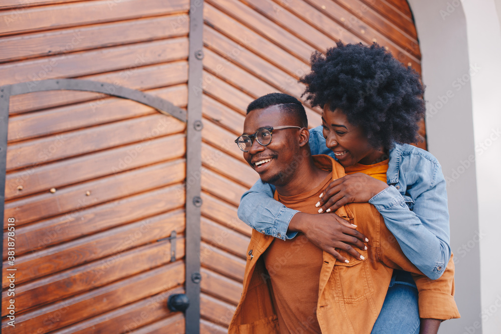 Young gorgeous hipster african couple having piggyback outdoors and having great time. Young gorgeous hipster african couple having piggyback outdoors and having great time.