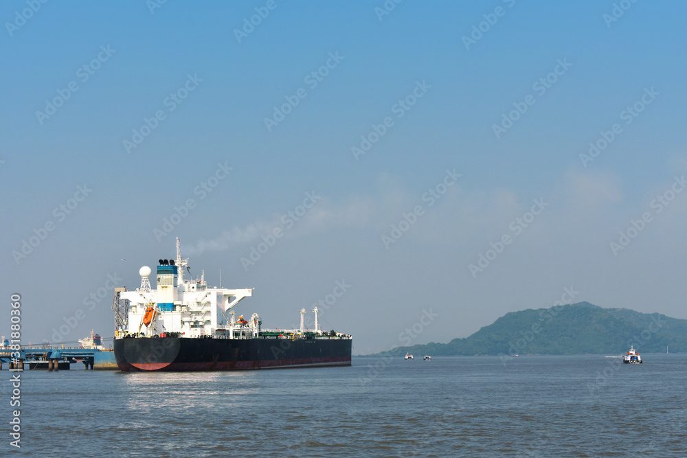 a huge merchant ship in the middle of the ocean