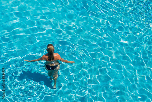 woman in luxury spa resort near the swimming pool.