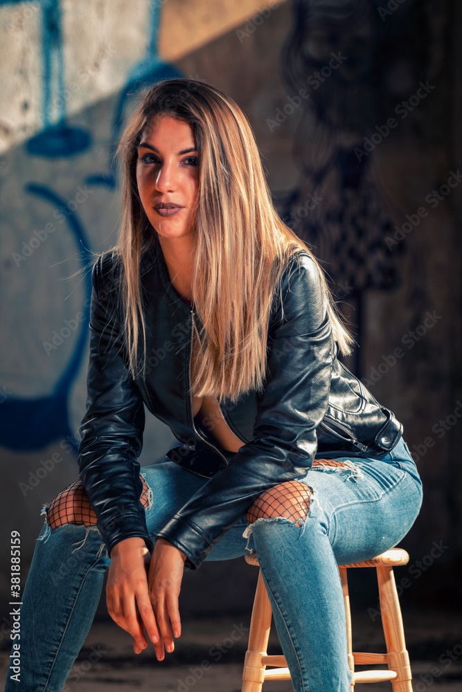 Model with leather jacket and blue jeans