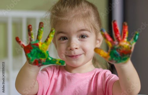 Little cute girl showing painted hands