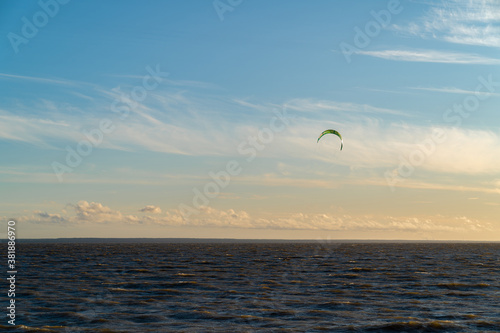 Beautiful sunset sky on the beach. Kitesurfing. Power kite. Beautiful scenery