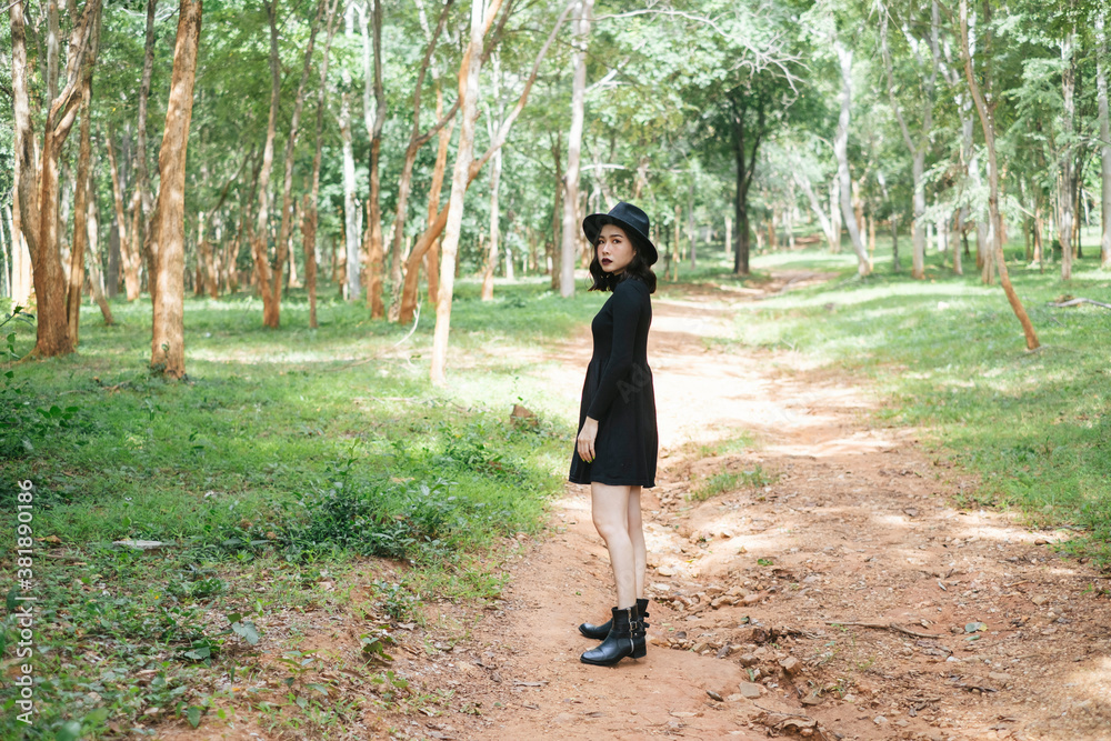 Portrait of asian black witch with hat in deep forest - halloween theme. Portrait of asian black witch with hat in deep forest - halloween theme.