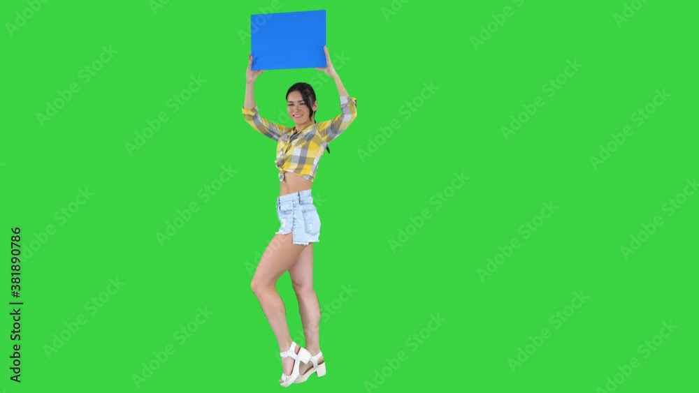 Girl with an empty board announcing new round on a Green Screen, Chroma Key. Girl with an empty board announcing new round on a Green Screen, Chroma Key.