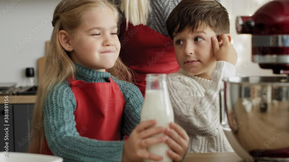 Video of little girl pouring milk into electric mixer bowl. Shot with RED helium camera in 8K. Video of little girl pouring milk into electric mixer bowl. Shot with RED helium camera in 8K.