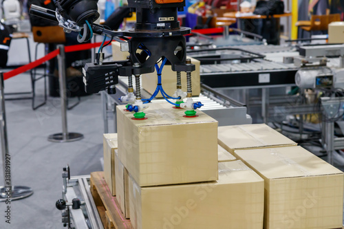 View of vacuum gripper on robot lifting the box. photo