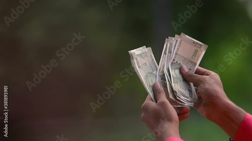 young indian farmer  counting money   at home