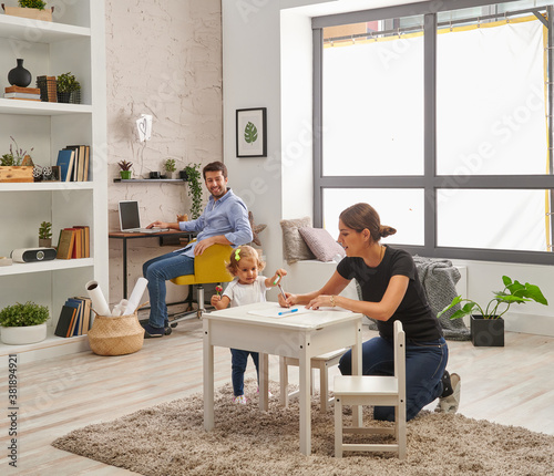 Man is working at home, mon is looking for her baby in the room.