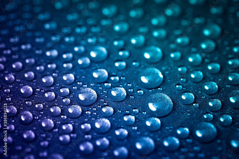 Lots of water droplets splattered on the shiny metallic texture. Blue-purple background color Lots of water droplets splattered on the shiny metallic texture. Blue-purple background color