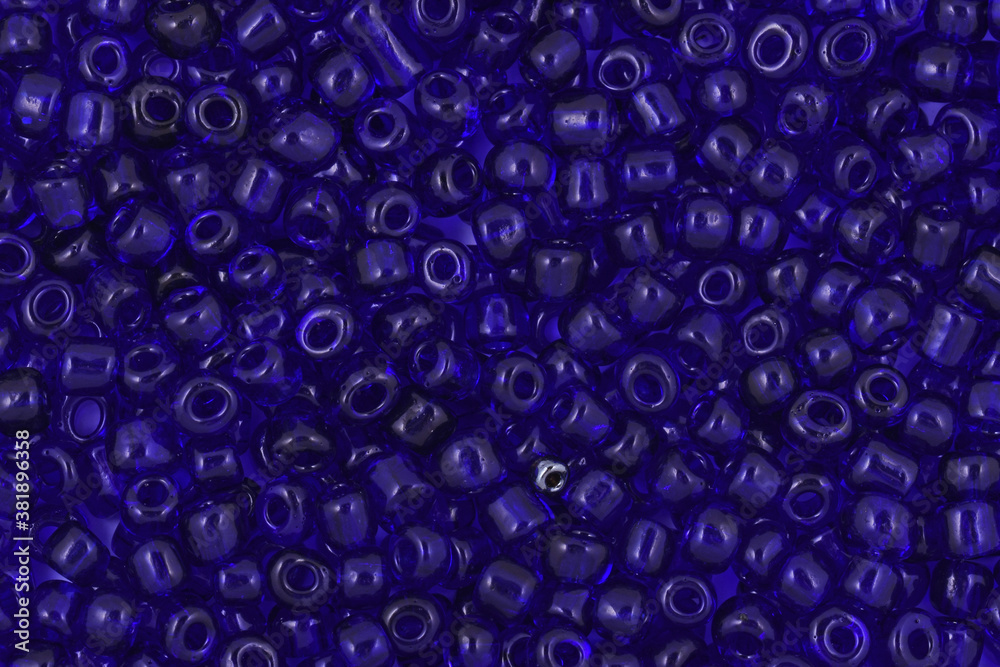 Blue Glass Seed Bead Background,Transparent beads on the white background. Background or texture of beads. Close up, macro,. make bead necklace or string of beads for woman of fashion.