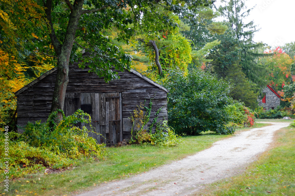 Grass pathway to the mill with waterwheel and waterfall in beautiful autumn, Sudbury, Massachusetts Grass pathway to the mill with waterwheel and waterfall in beautiful autumn, Sudbury, Massachusetts