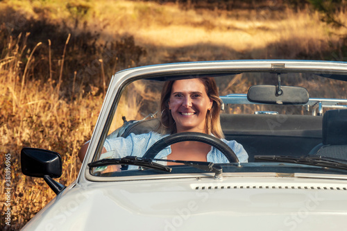 Woman with white convertible vintage car