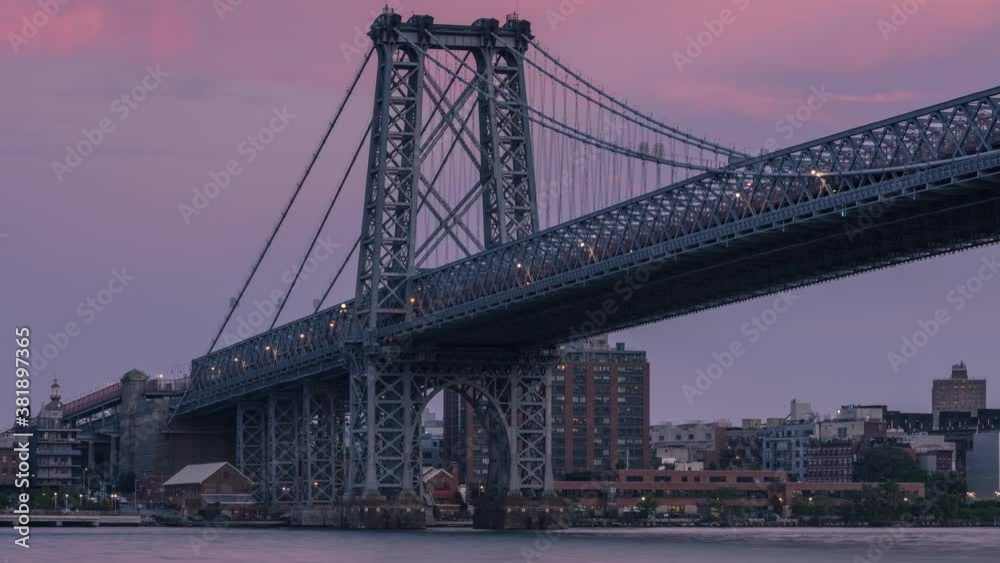 A full moon rises over Williamsburg bridge in day to night time lapse A full moon rises over Williamsburg bridge in day to night time lapse