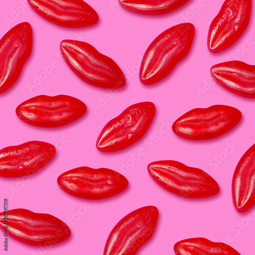Top view of many jelly candy lips on a pink background